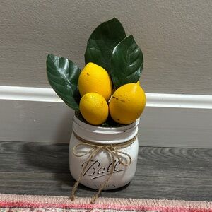 White Jar with Yellow Lemons and Green Leaves